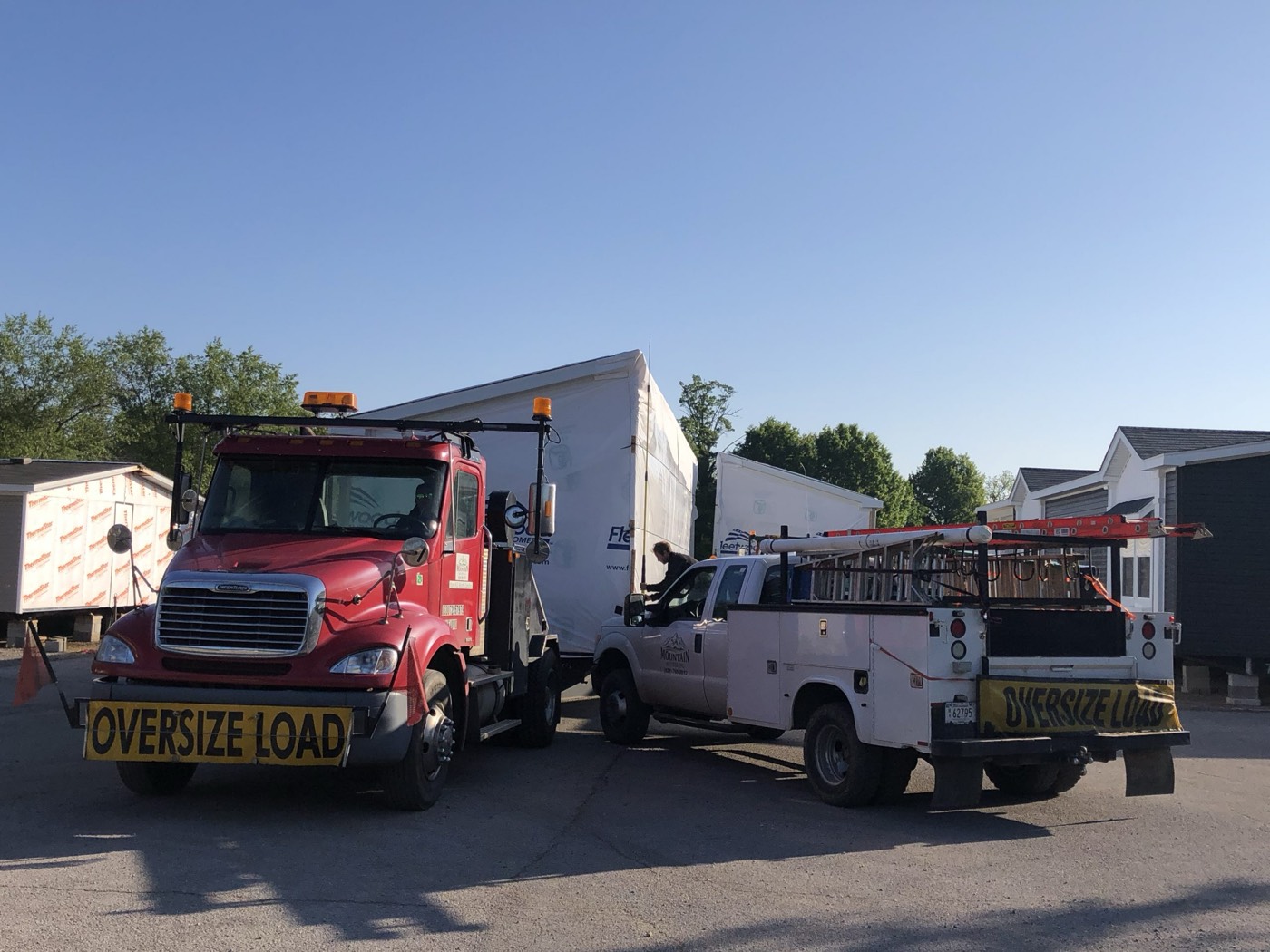 Toter truck hitched to a home in a lot