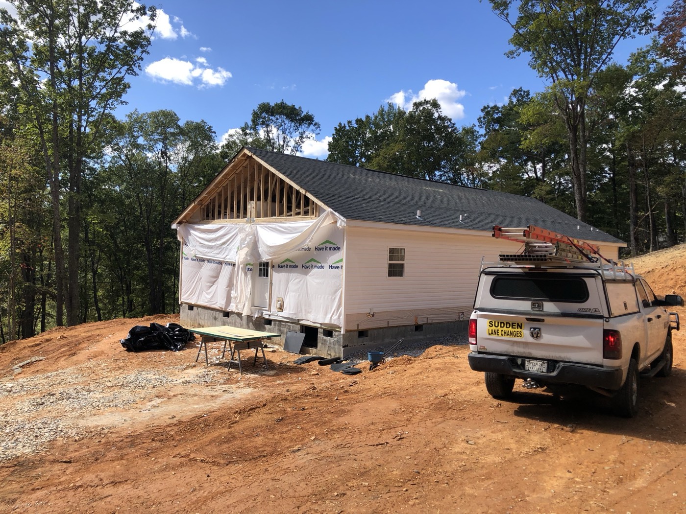 Plastic-wrapped home being moved