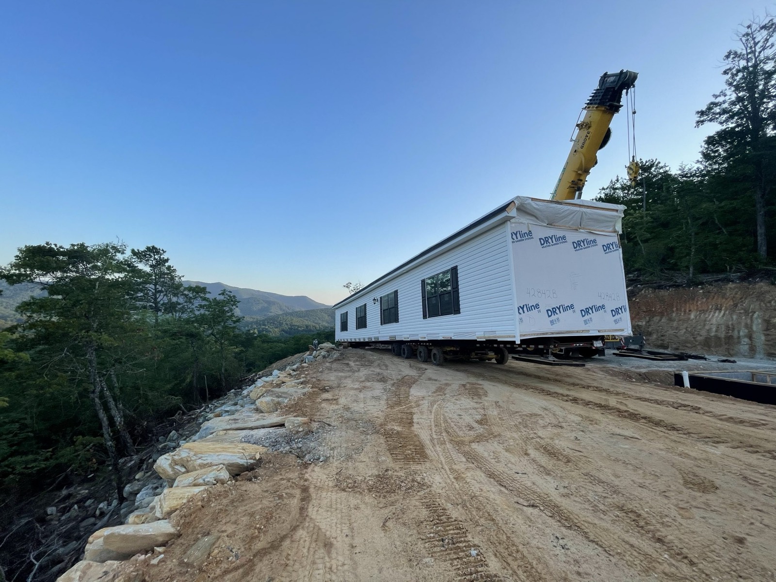Setting a home on a mountain ridge at dusk