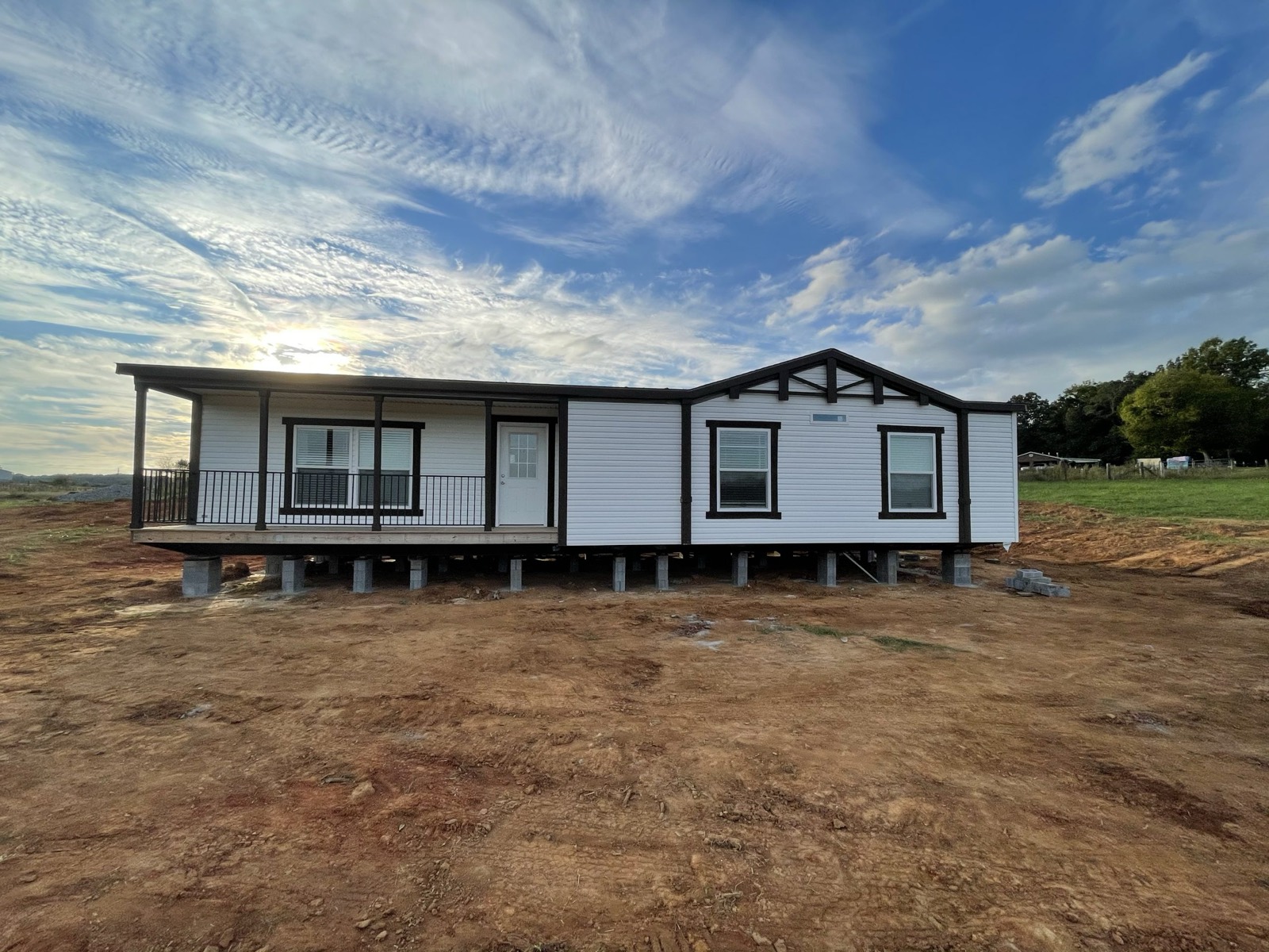 Home set in an open field at dusk
